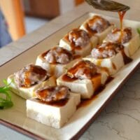 Pouring sauce over stuffed tofu