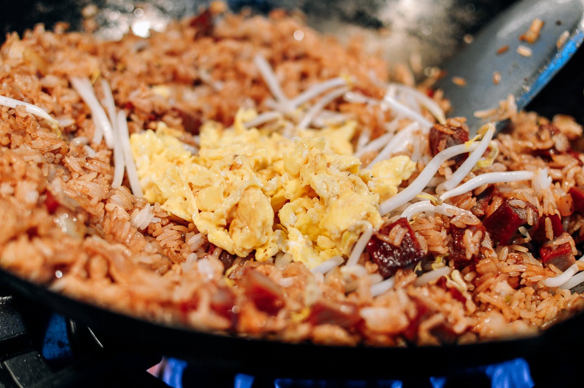 scrambled egg added to bean sprouts and rice