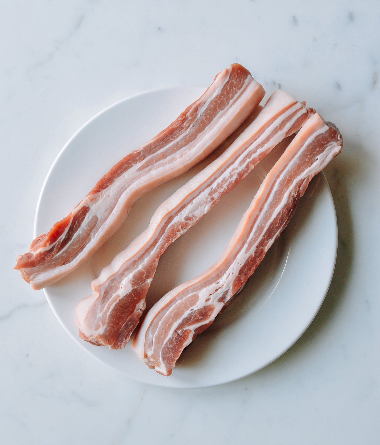 three strips of skin-on pork belly
