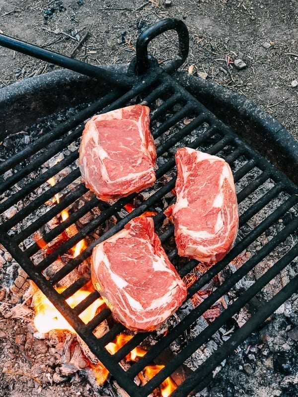 Grilling steak on a fire ring in campground, cwww5.fioekdjsdas.cf