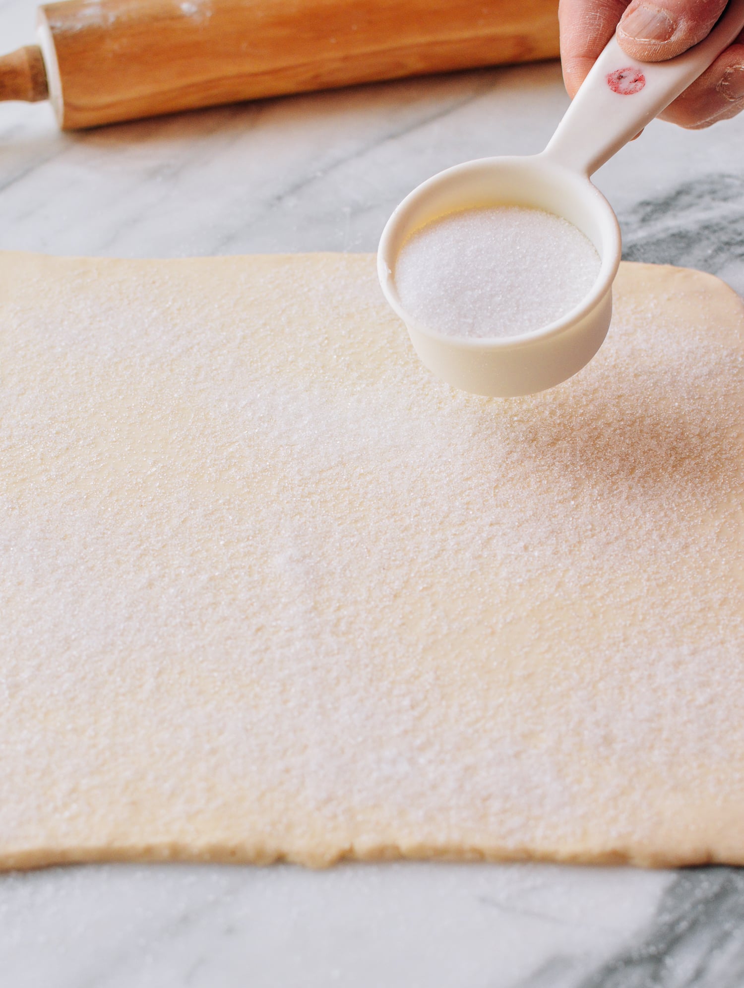 Spreading sugar on top of puff pastry dough, cwww5.fioekdjsdas.cf