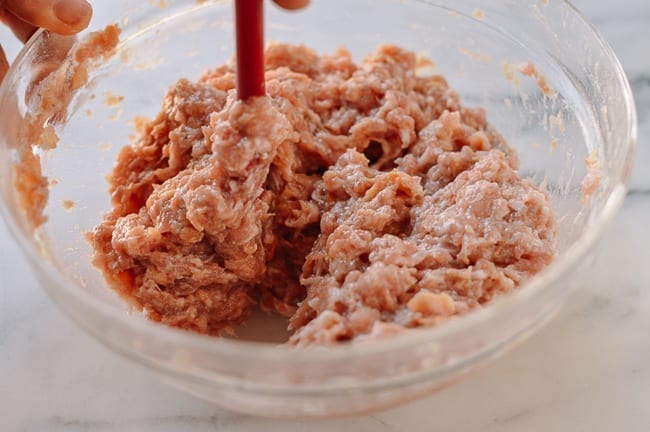 Stirring Chinese meat mixture until it resembles a paste, cwww5.fioekdjsdas.cf