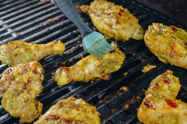 Basting gai yang chicken with marinade, cwww5.fioekdjsdas.cf