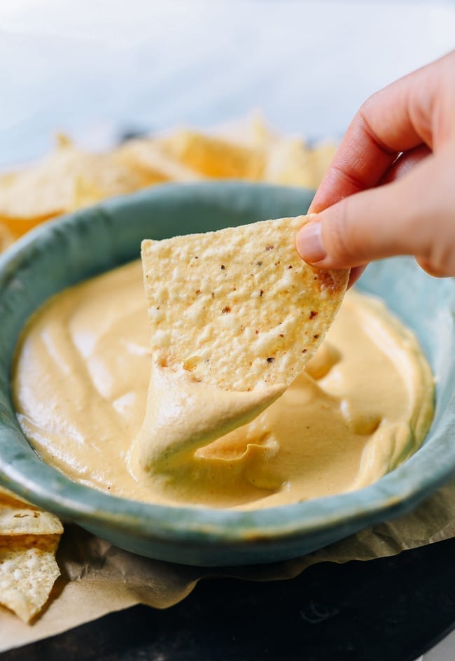 Dipping tortilla chip into plain vegan queso, cwww5.fioekdjsdas.cf