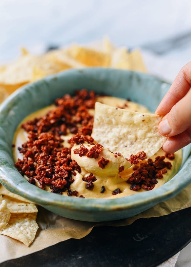 Dipping chip into vegan queso, cwww5.fioekdjsdas.cf