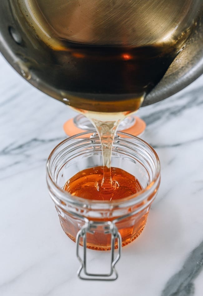 Pouring warm golden syrup into heatproof airtight container, cwww5.fioekdjsdas.cf