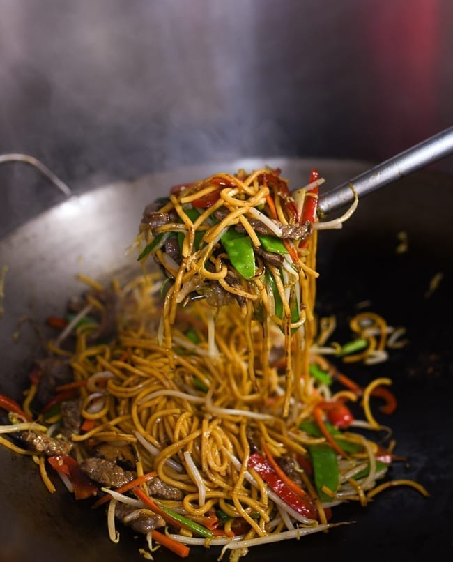 Lifting lo mein with wok spatula, cwww5.fioekdjsdas.cf