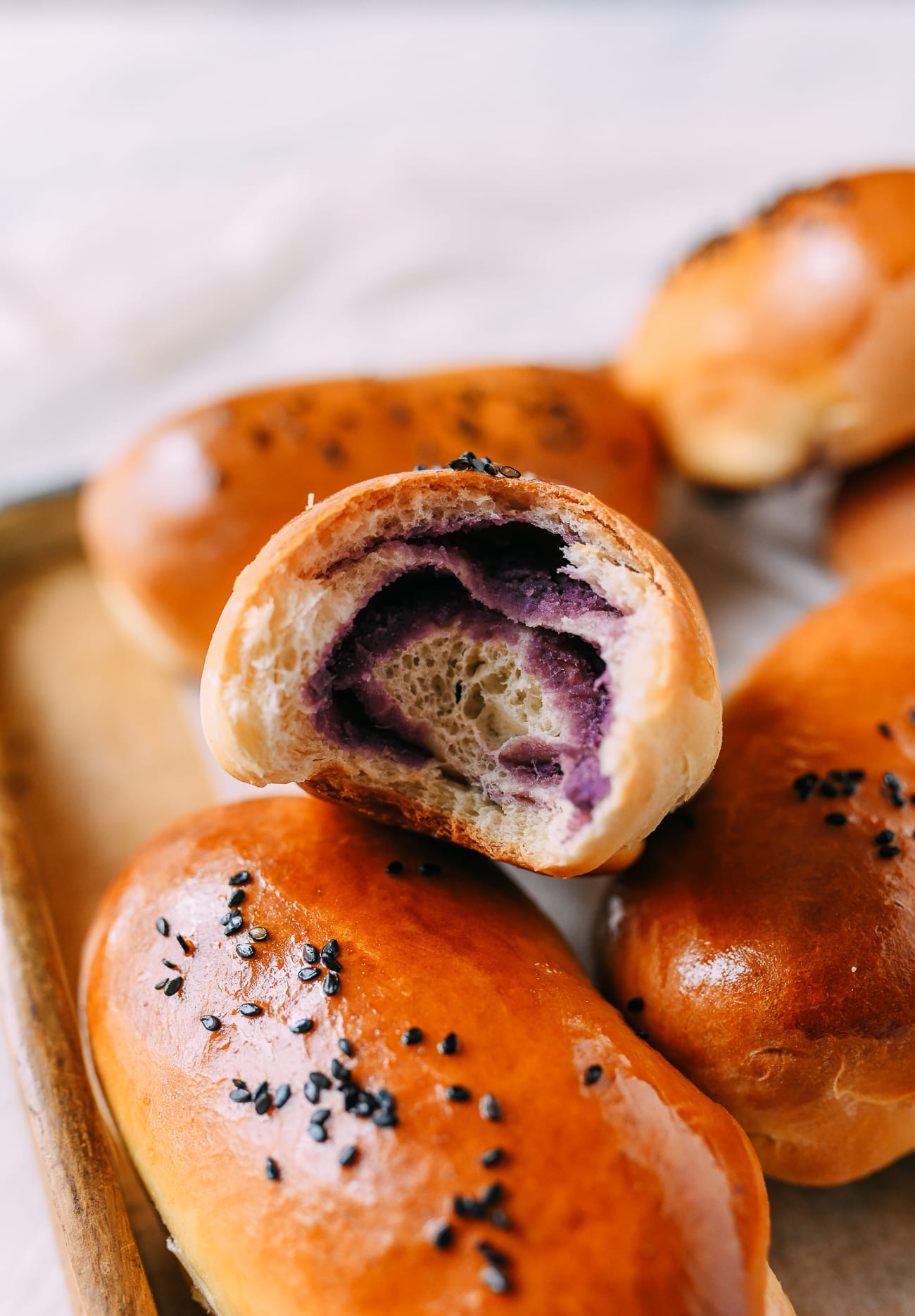 Ube bun with a bite taken out of it