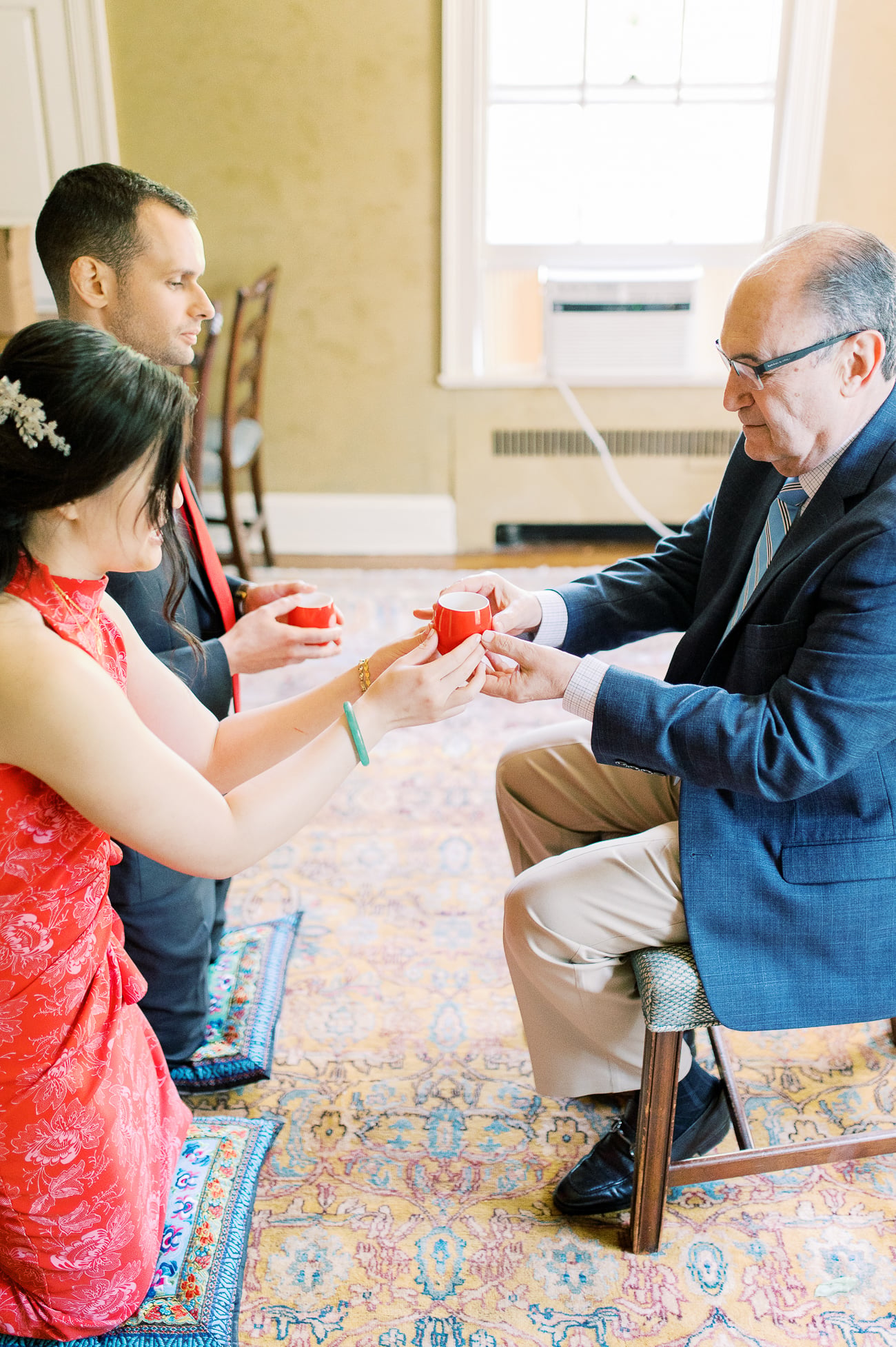 Sarah and Justin serving tea to Justin's dad