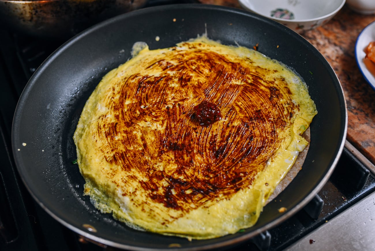 spreading tianmianjiang on egg
