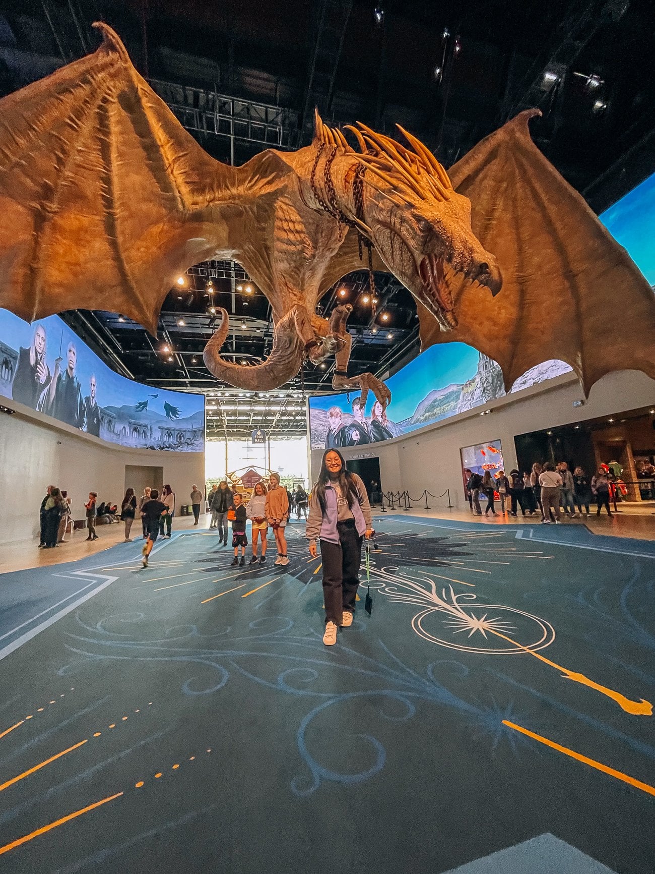 Kaitlin underneath a giant Ukrainian Ironbelly dragon from Harry Potter and the Deathly Hallows
