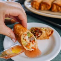 dipping egg roll in duck sauce