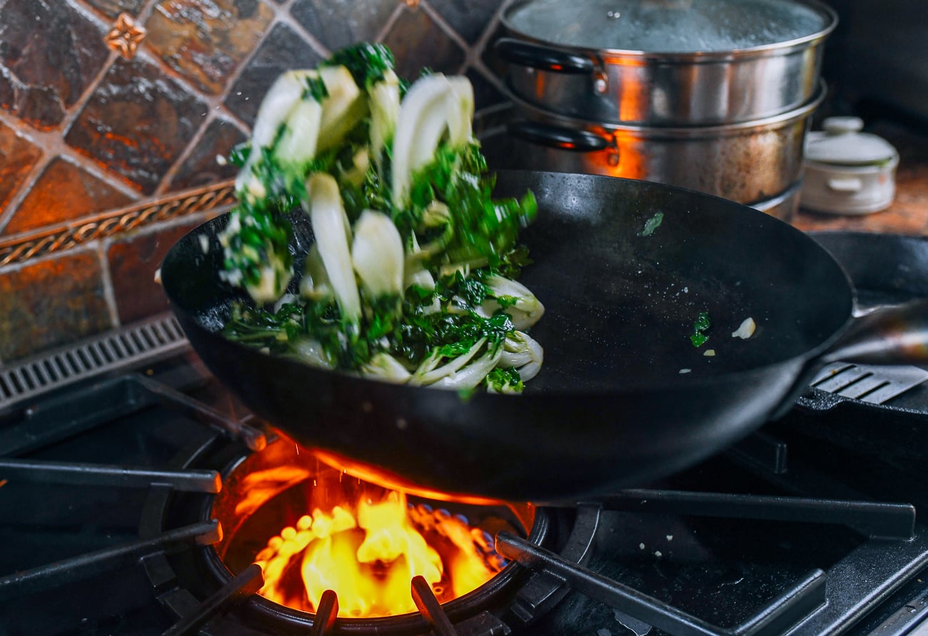 tossing dwarf bok choy in wok