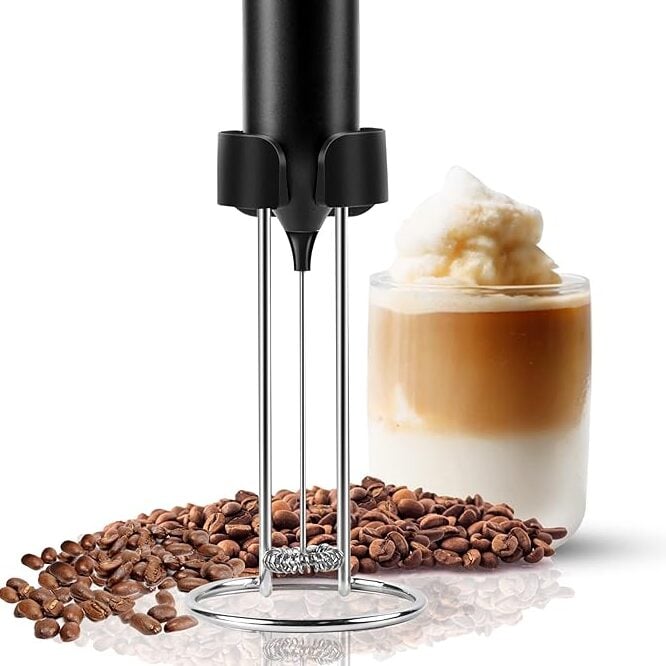 electric milk frother wand with foamy coffee drink and coffee beans