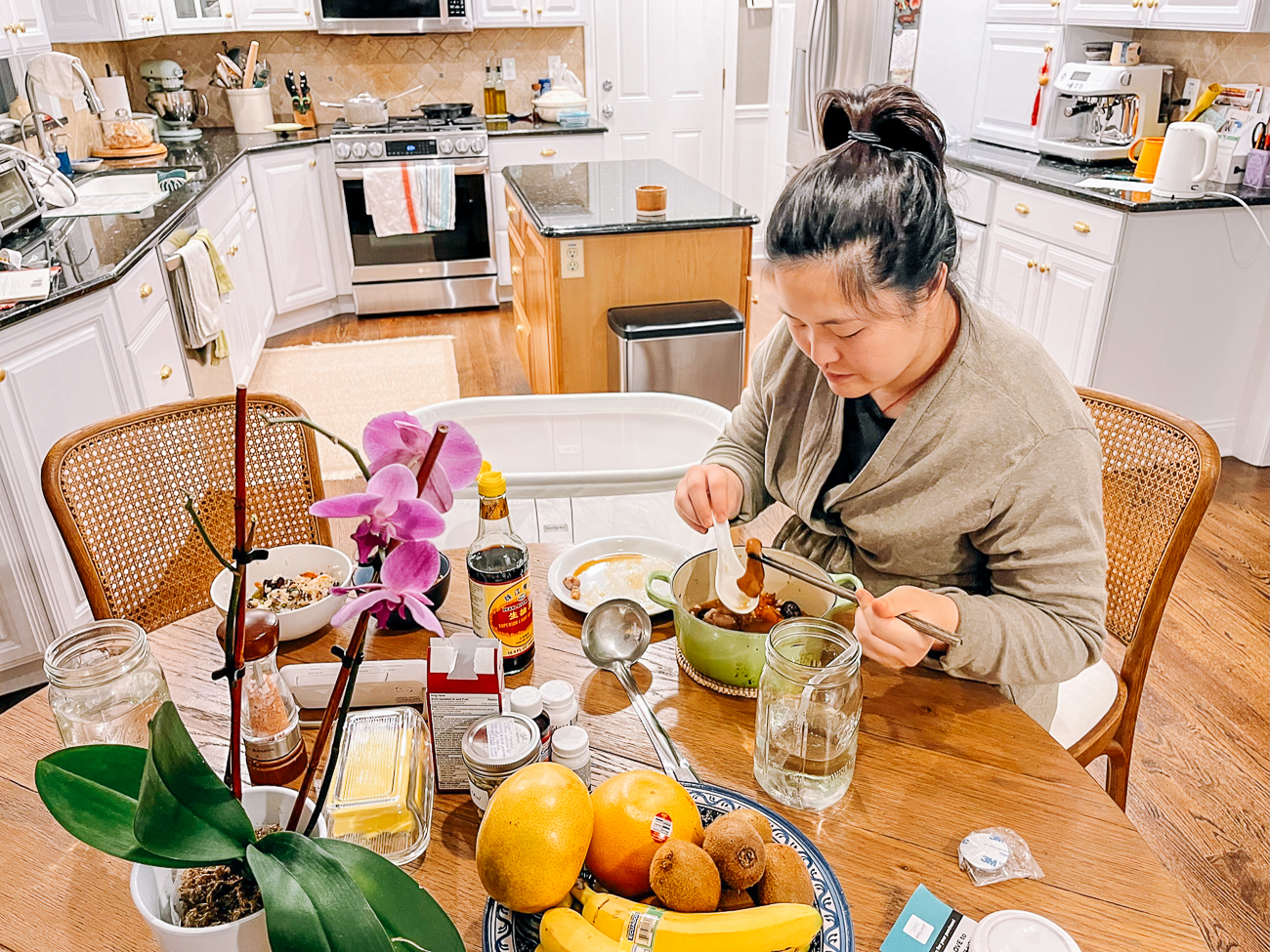 sarah eating soup at kitchen table