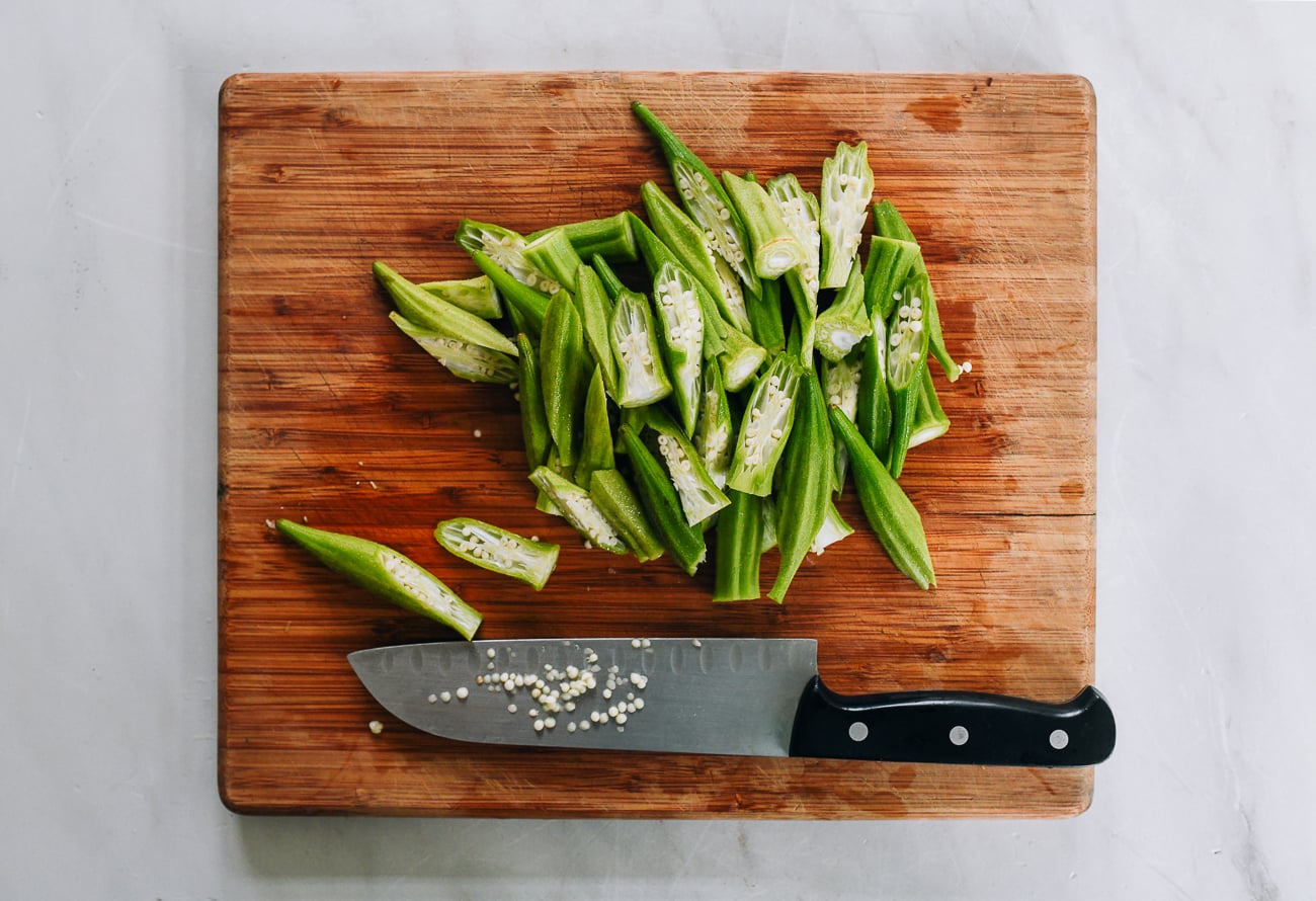 okra cut on a sharp angle into pieces for stir-fry