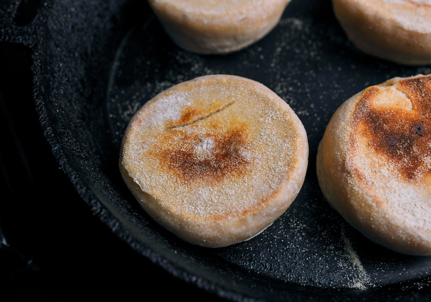 cooked english muffins in cast iron skillet