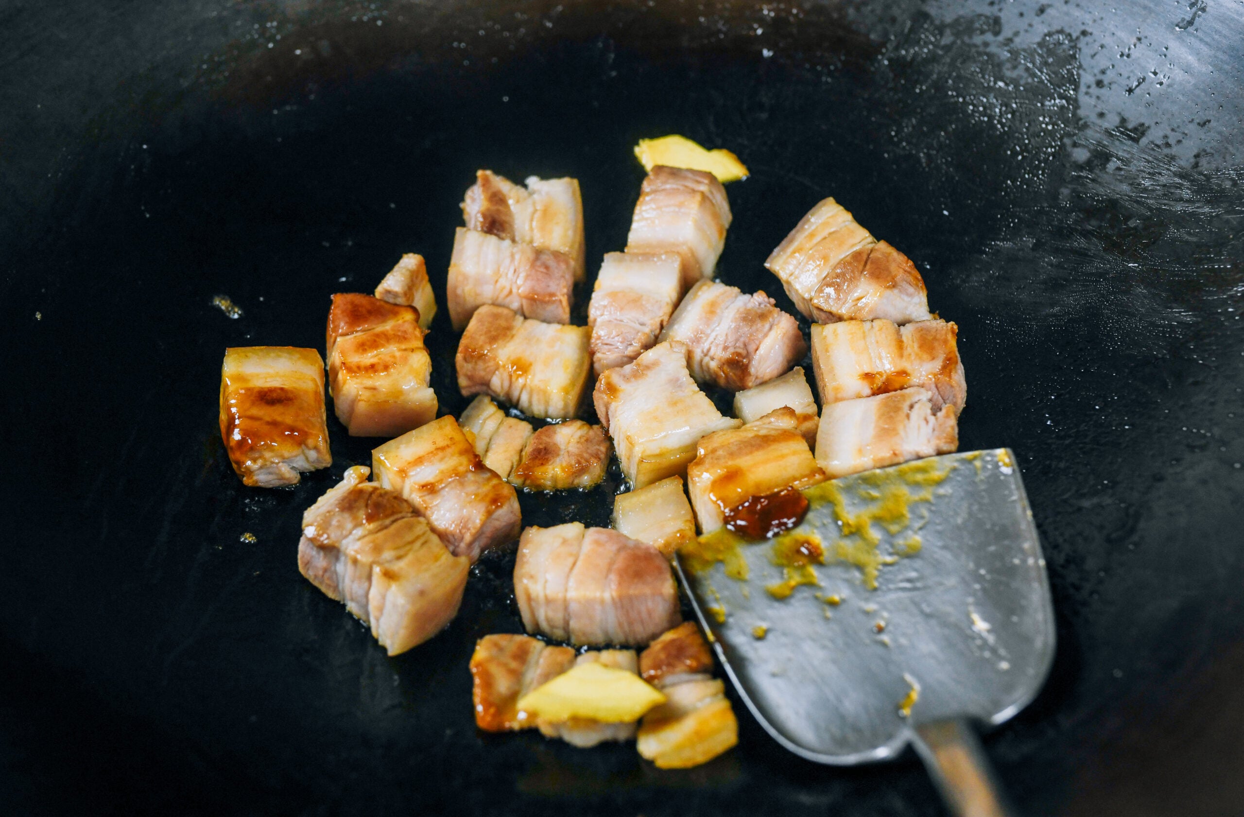browning pork belly in wok
