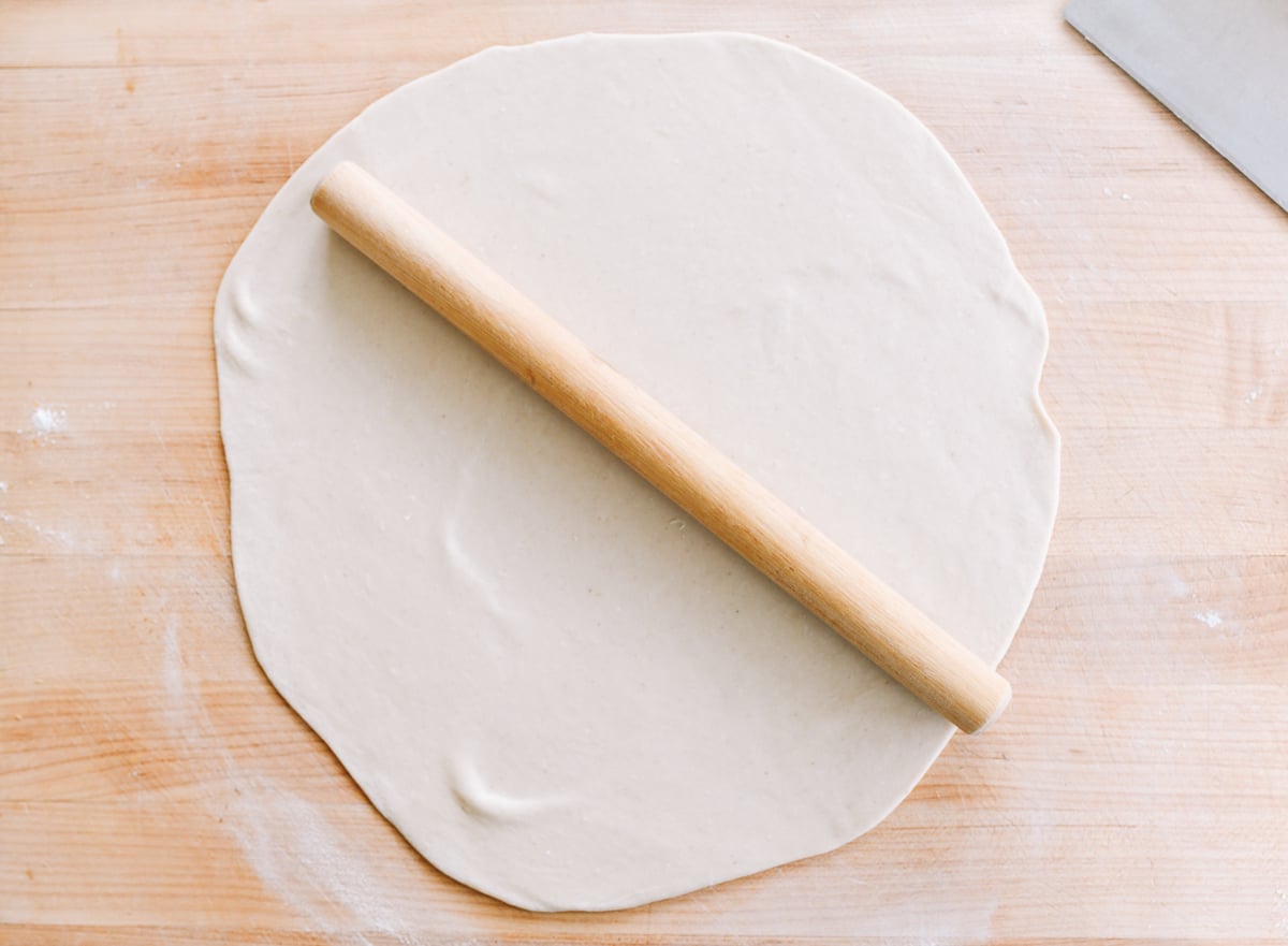 dough rolled out into thin, large circle