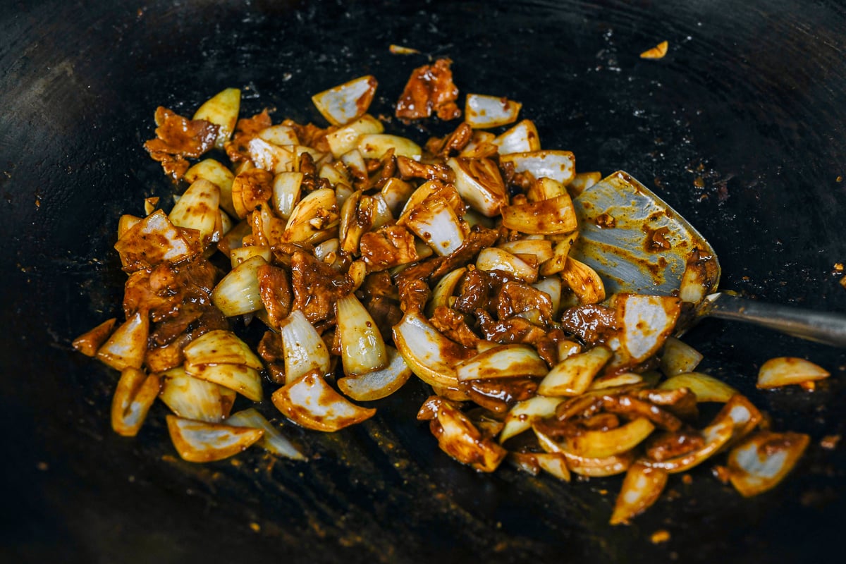 pork onion stir-fry in wok