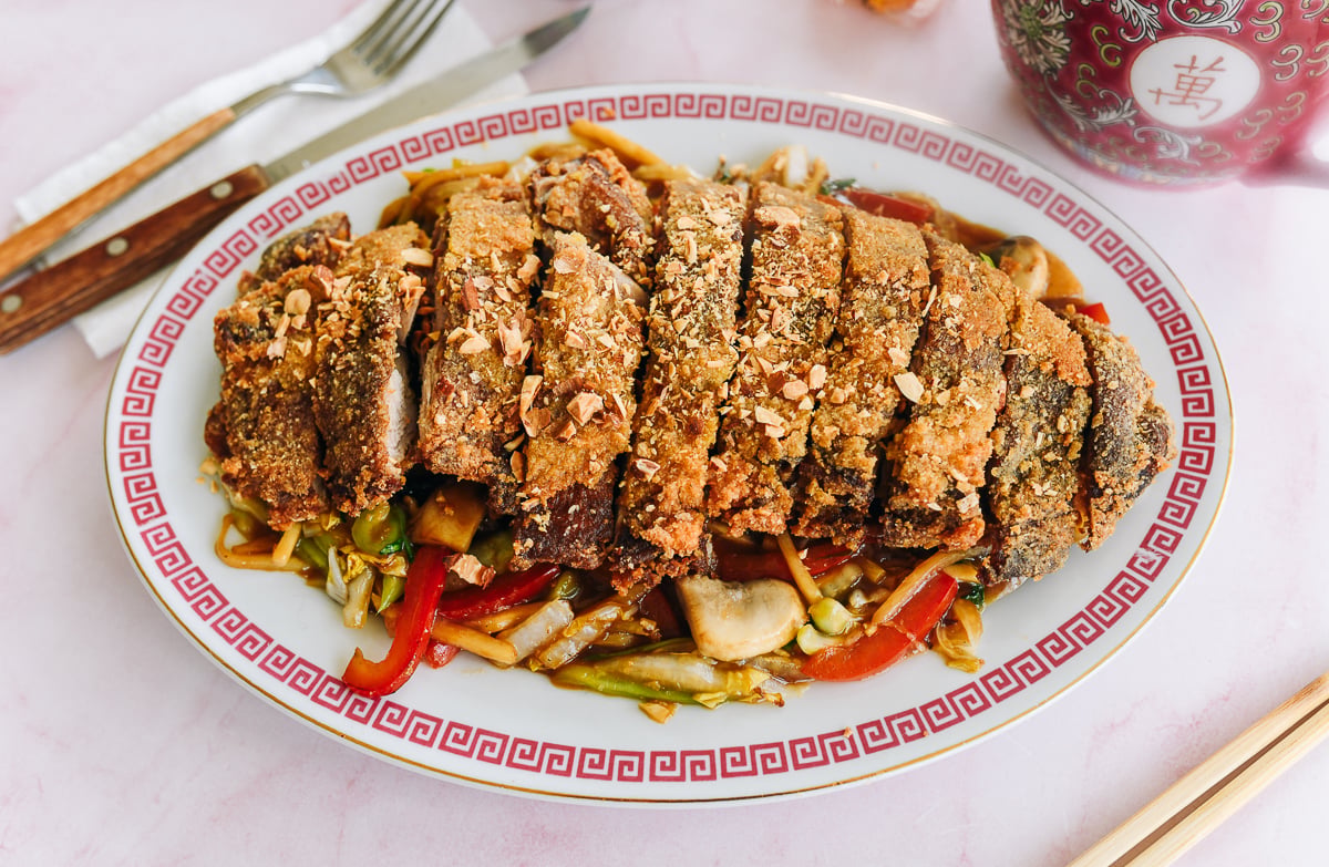 Chinese pressed duck on a bed of vegetables with almonds on top