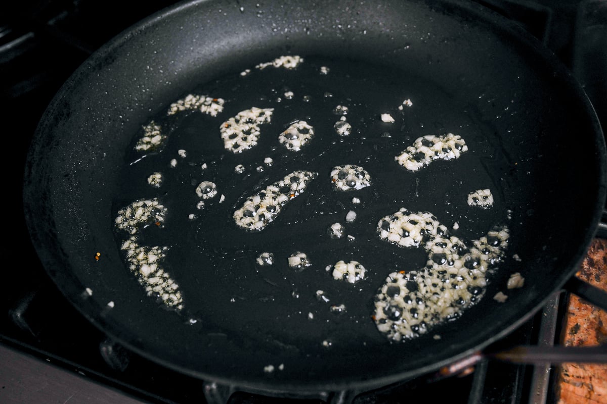 cooking garlic in oil in pan
