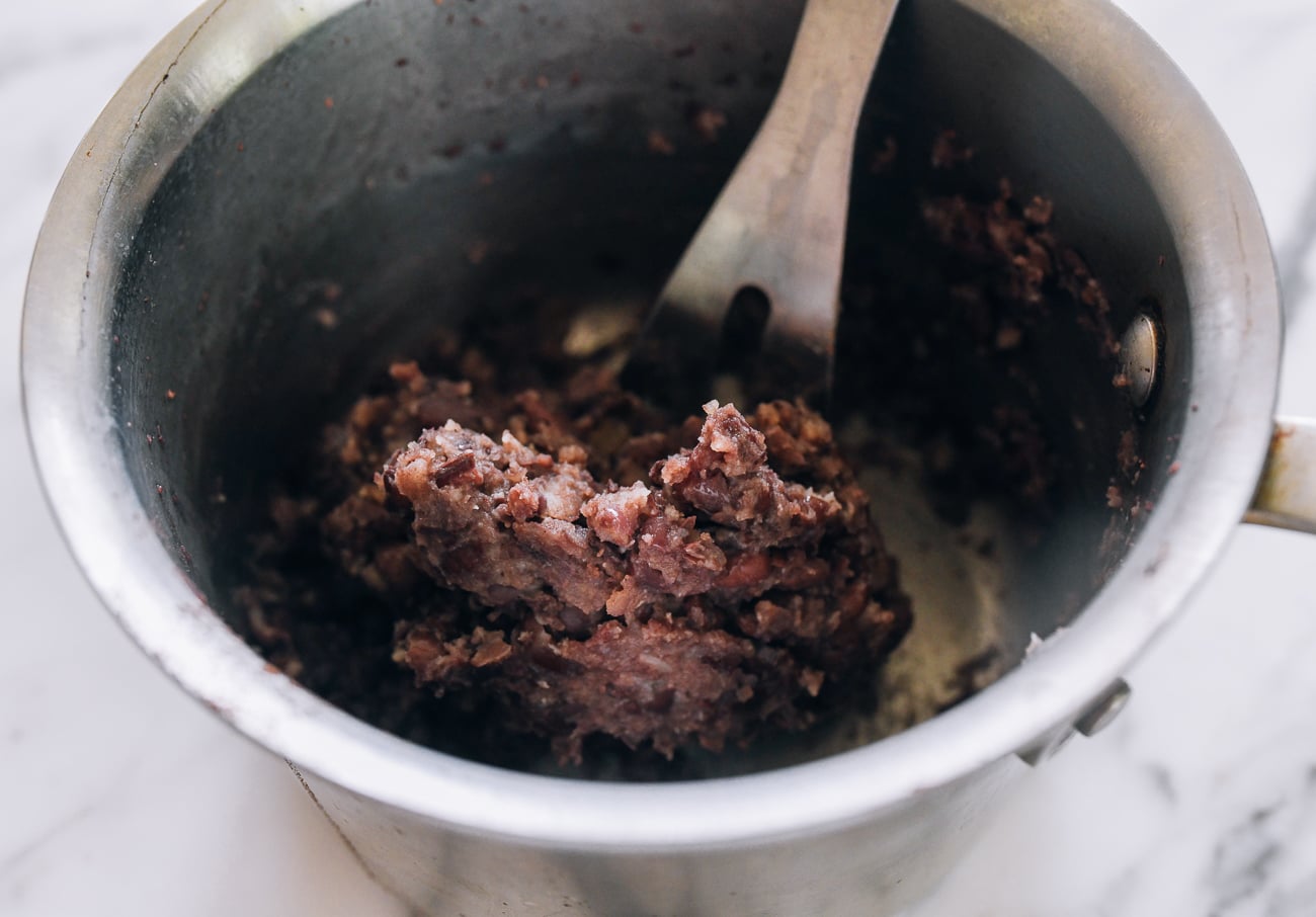 mashed cooked red beans in pot
