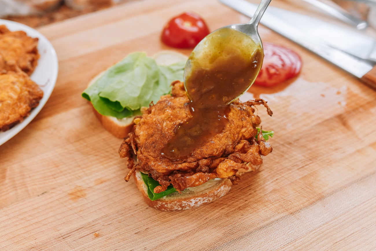 ladling gravy onto egg foo young patty