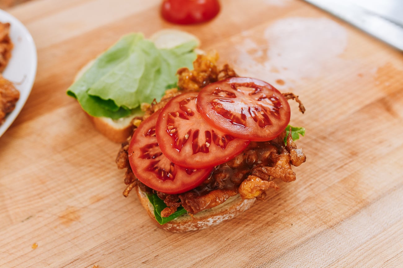 tomato slices on egg foo young sandwich
