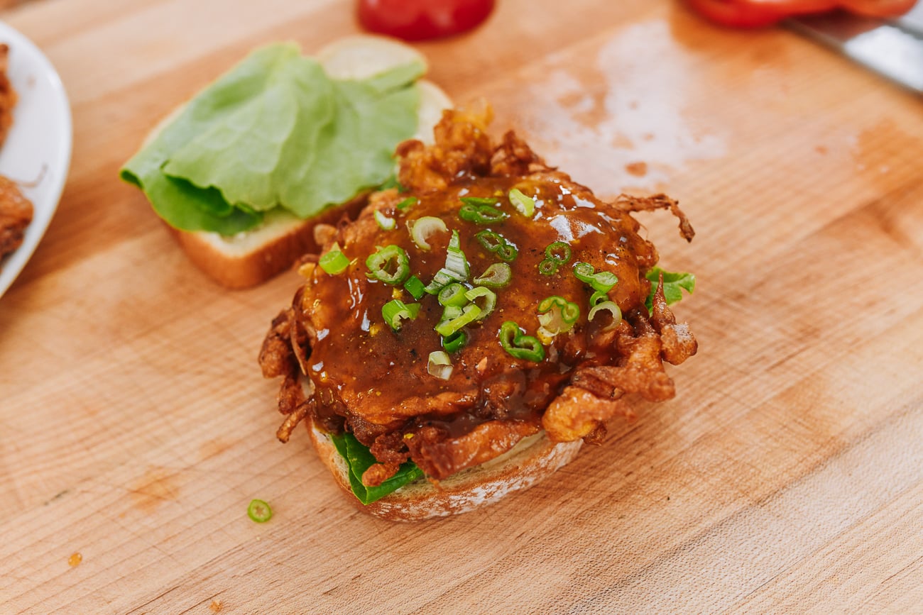 chopped scallions on egg foo young patty 